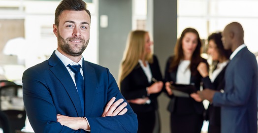 Businessman leader in modern office with businesspeople working